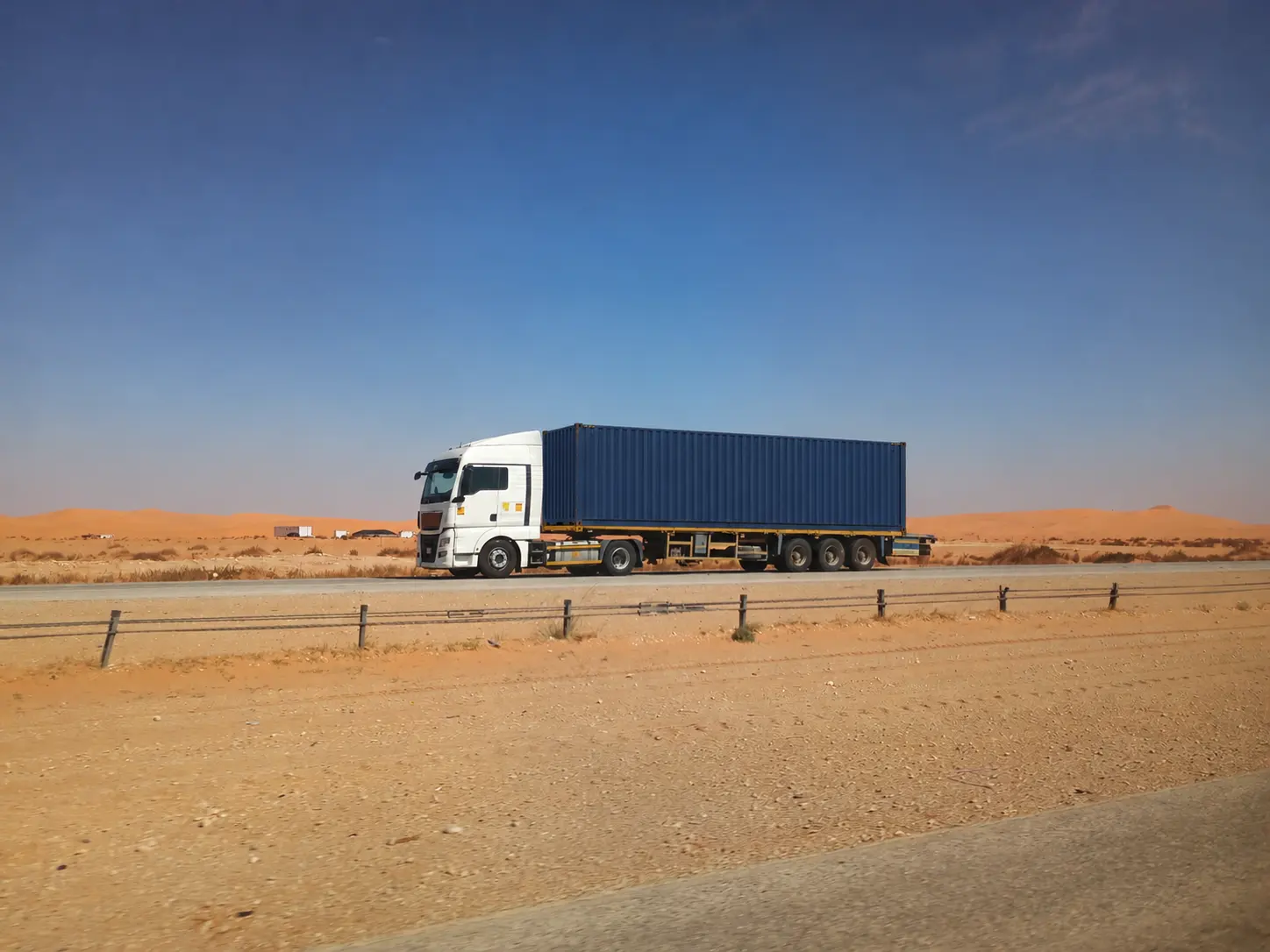Flatbed truck carrying a shipping container in Saudi Arabia