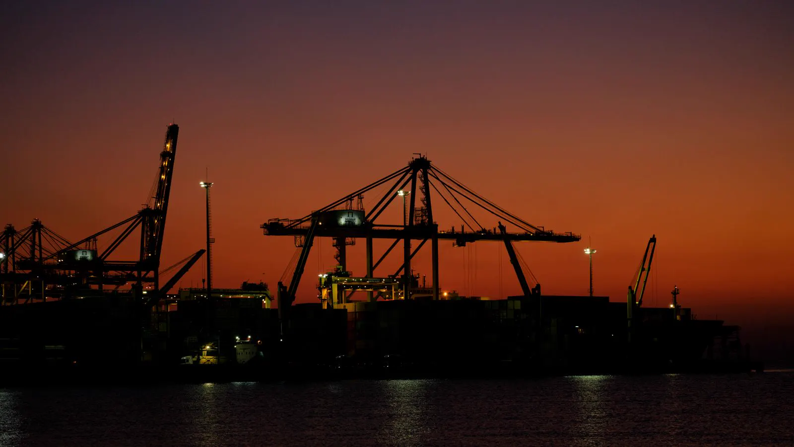 Port cranes at sunset
